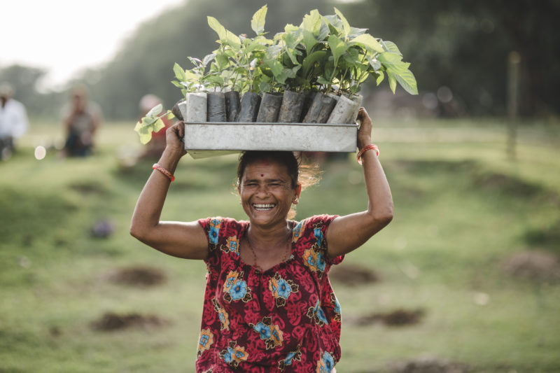 woman smiling with seedling box