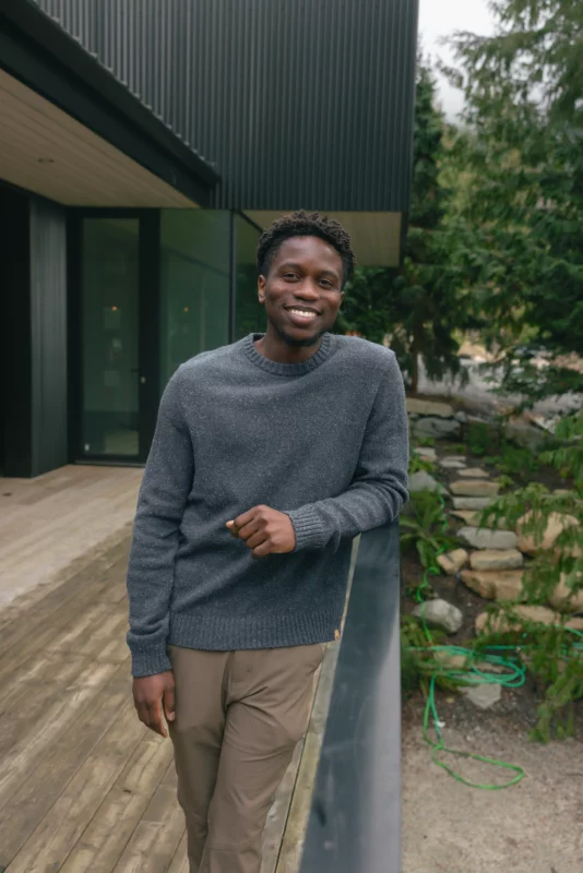 Model wearing tentree sustainable apparel Highline Nep Crew Sweater outside cabin