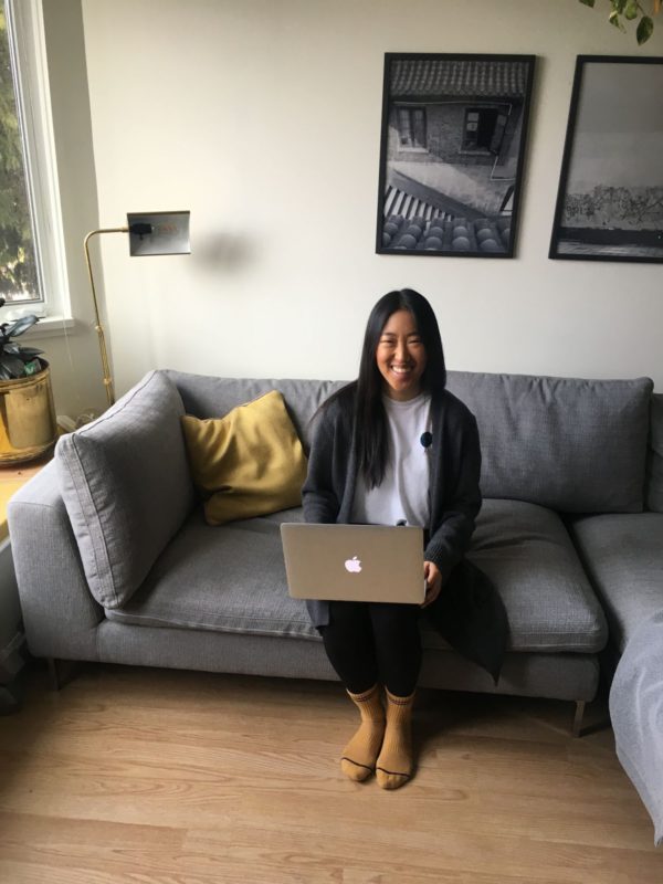 Woman sitting on a couch with her laptop
