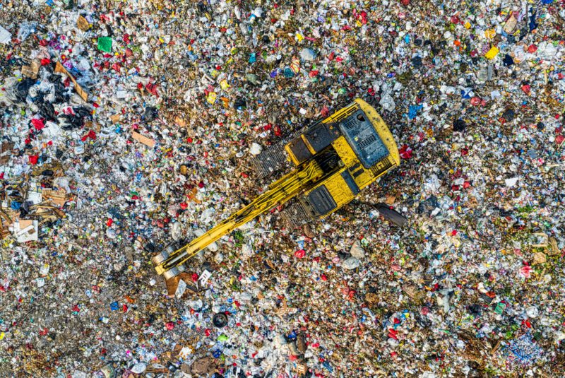 Landfill showing clothing. tentree apparel, including outerwear, is free from forever chemicals, which are toxic and make garments difficult to recycle.